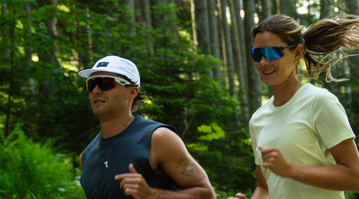 Couple is running through the forest