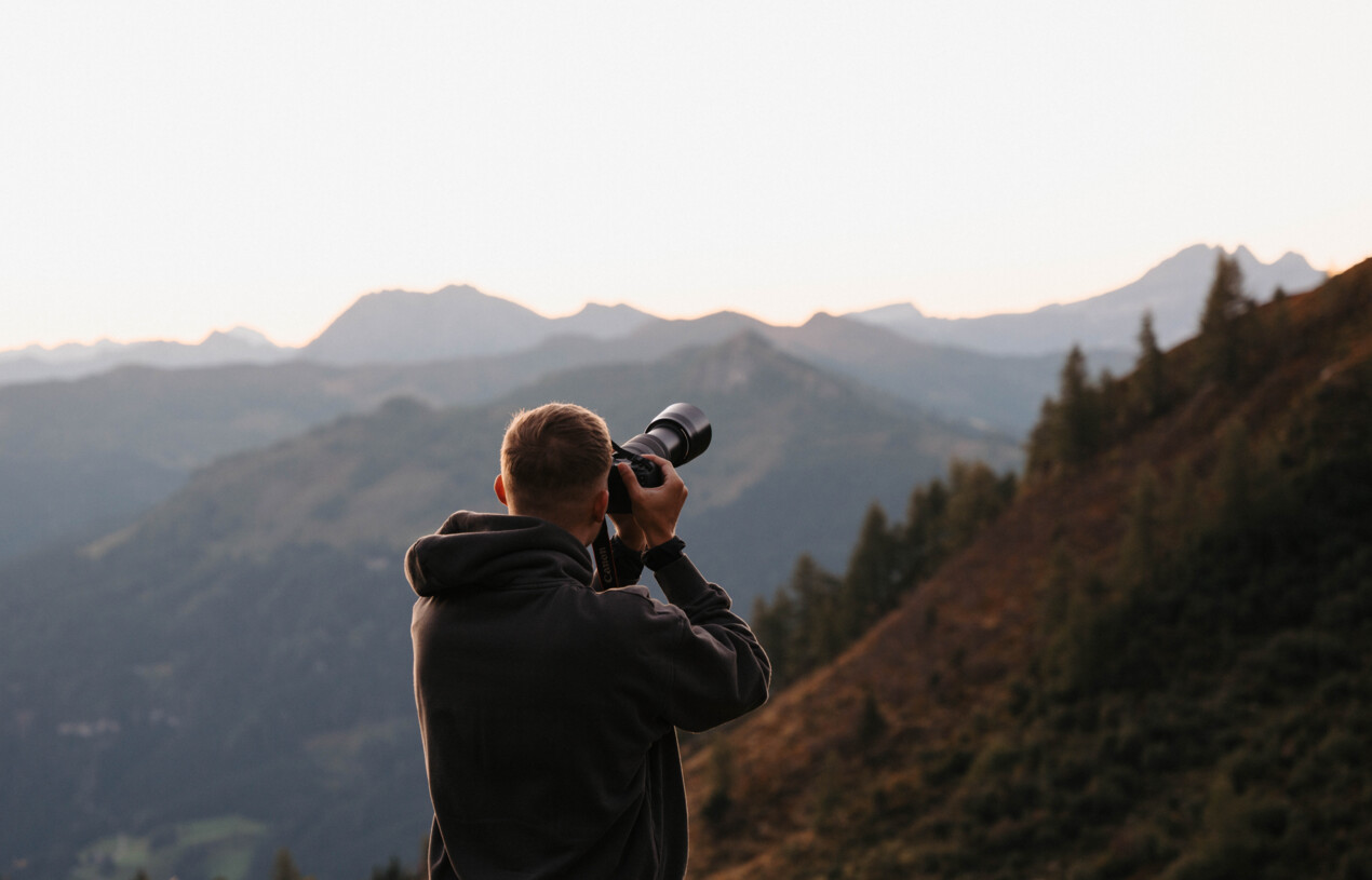 Man is taking pictures from the mountains with the Leica Camera