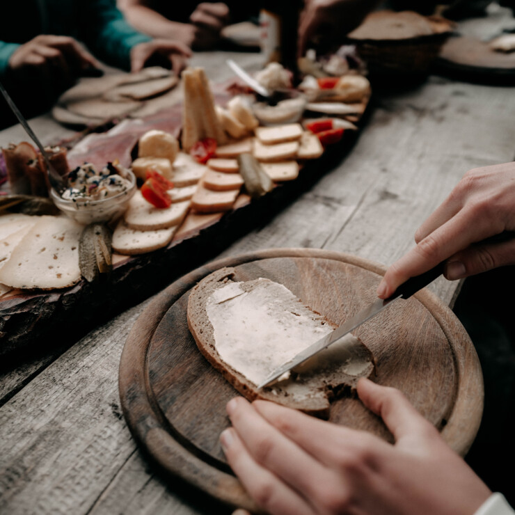 Traditional alpine snack with buttered bread served on a wooden board